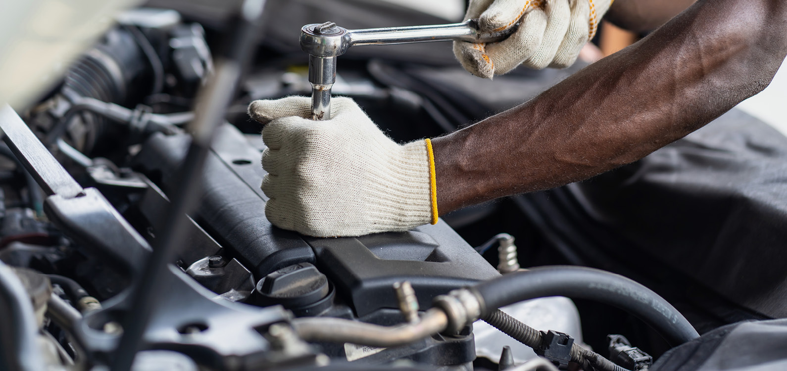 Mechanic hands working an an engine